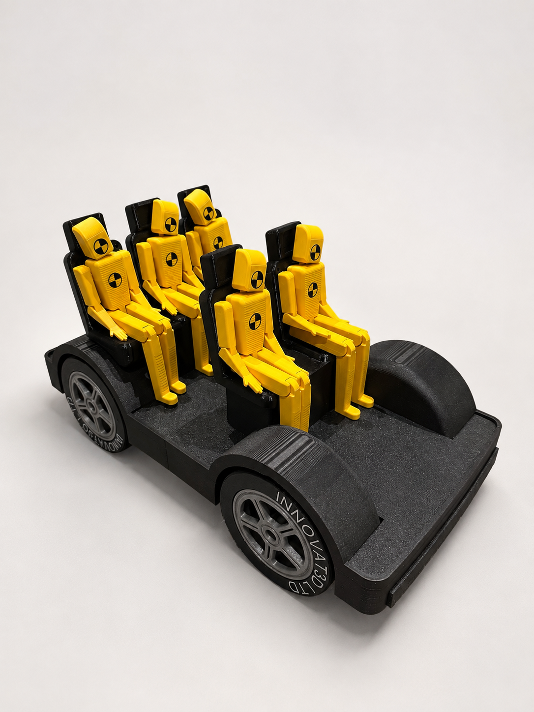 Demonstration chassis with five articulated crash-test-style occupants seated and belted