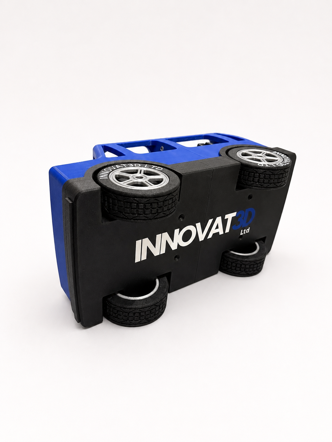 Underside of the demonstration car showing the Innovat3D Ltd branding and bearing-supported wheels