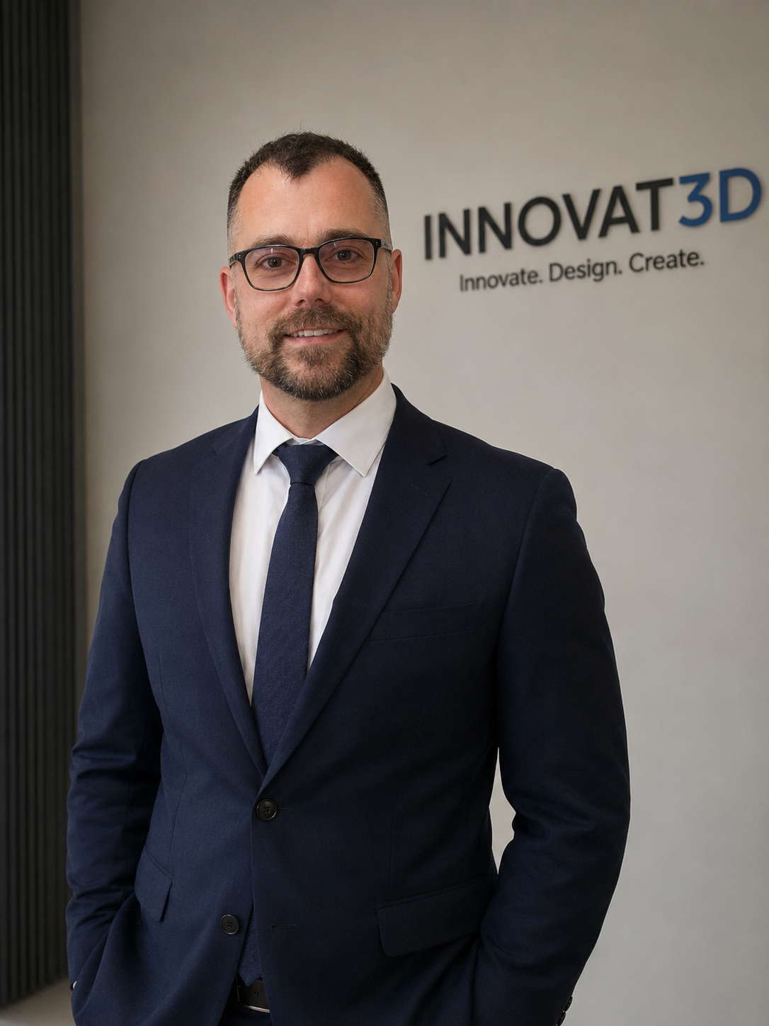 Founder of Innovat3D Ltd standing in front of the company logo